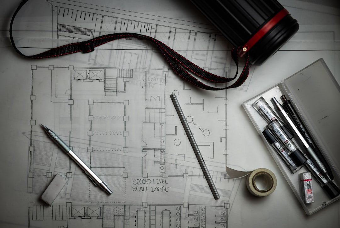Architectural blueprints and drafting tools on a desk